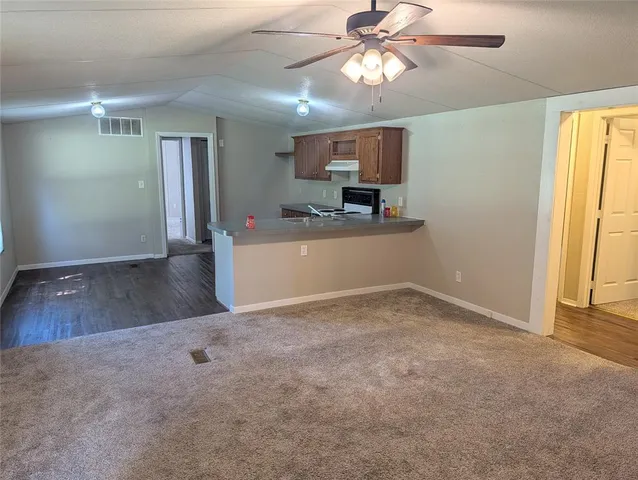 a view of a kitchen with a sink and a window