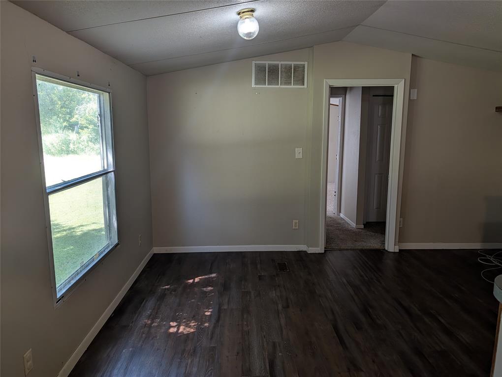 11478 Gordon Lane Mabank, TX 75147 - Photo 8 of 27 an empty room with wooden floor and windows