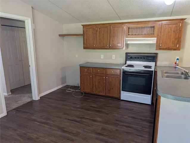 a kitchen with wooden floors and a sink