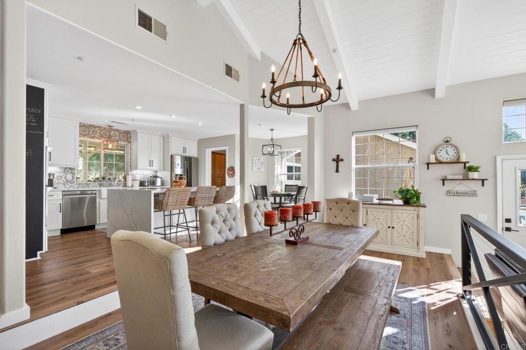25350 Mesa Grande Road Santa Ysabel, CA 92070 - Photo 17 of 55 a view of a dining room with furniture a chandelier and wooden floor