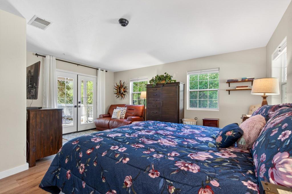 25350 Mesa Grande Road Santa Ysabel, CA 92070 - Photo 26 of 55 a large bedroom with a bed and wooden floor