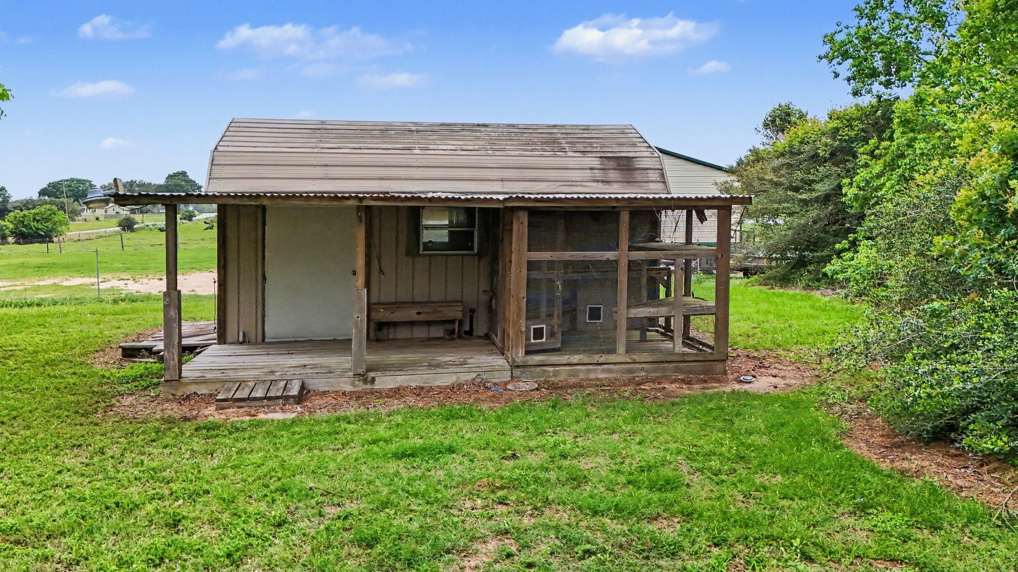 35564 Brumlow Road Hempstead, TX 77445 - Photo 29 of 46 a view of a house with a yard and lawn chairs with plants