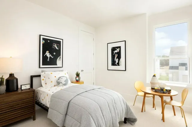 a bedroom with a bed and a table