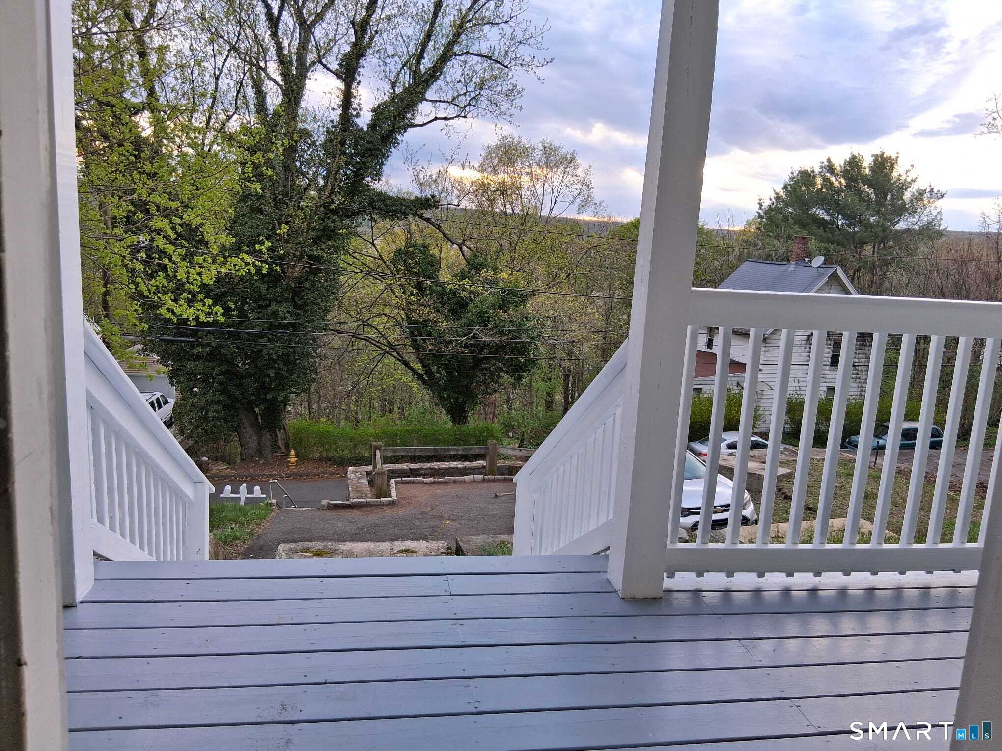 100 Mt Pleasant Street Derby, CT 06418 - Photo 1 of 6 a view of balcony with wooden floor and fence