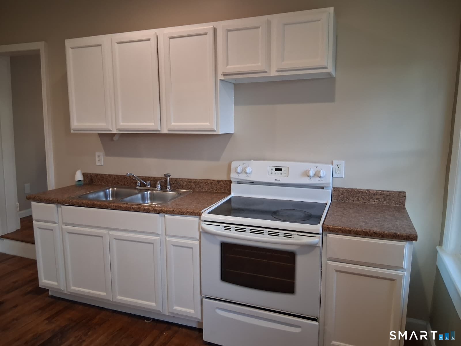 100 Mt Pleasant Street Derby, CT 06418 - Photo 5 of 6 a kitchen with granite countertop white cabinets and white appliances