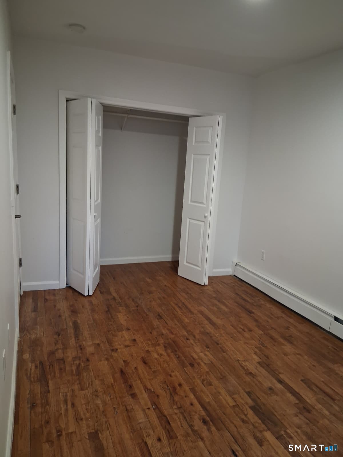 100 Mt Pleasant Street Derby, CT 06418 - Photo 6 of 6 a view of an empty room with wooden floor and closet