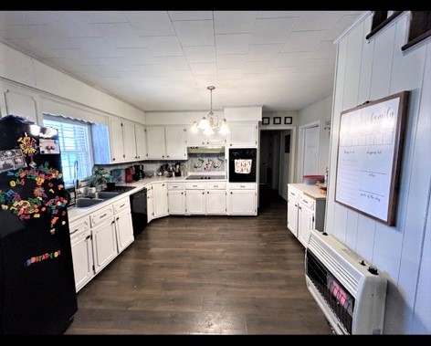 828 Rabbit Trail Road Five Points, TN 38457 - Photo 9 of 16 a large kitchen with cabinets wooden floor and stainless steel appliances