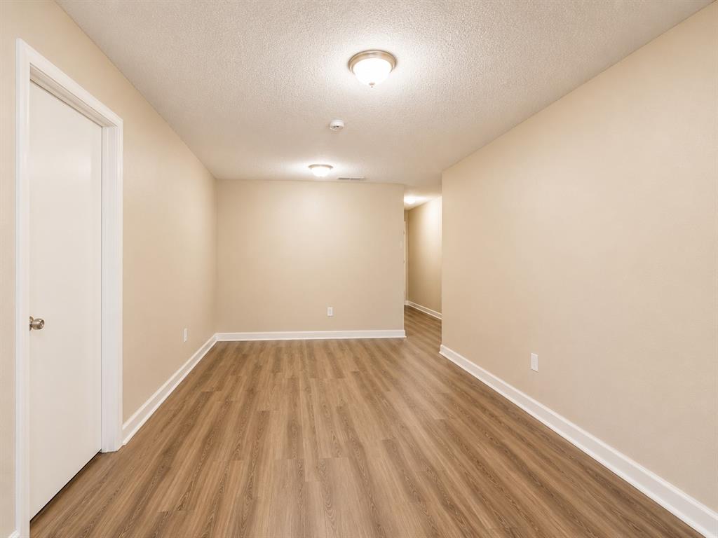 1231 Rutherford Drive Mesquite, TX 75149 - Photo 23 of 29 a view of an empty room and wooden floor