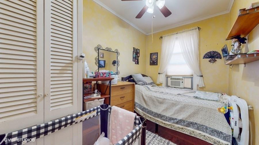 340 86th Street Brooklyn, NY 11209 - Photo 11 of 20 a bed sitting in a bedroom next to a window