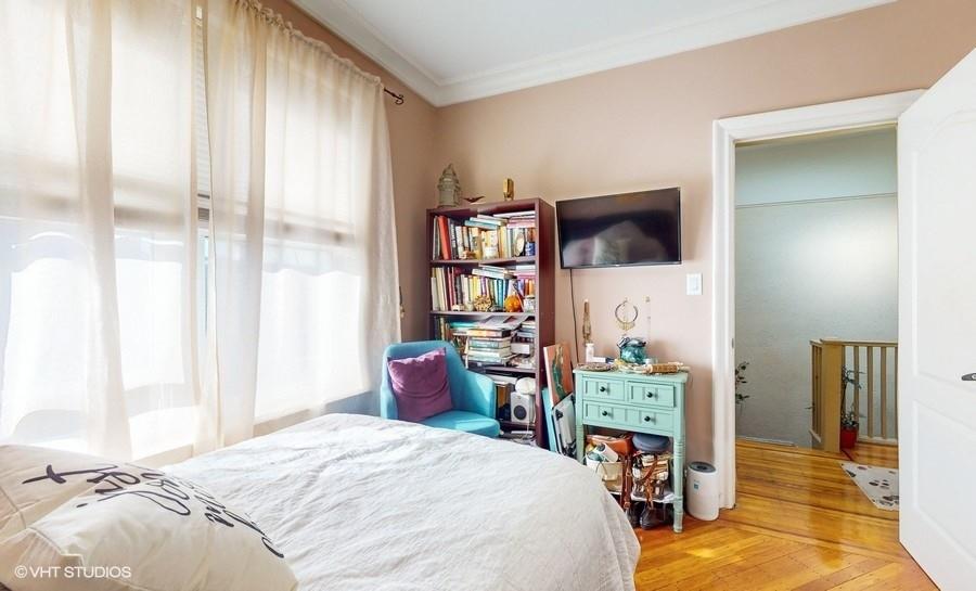 340 86th Street Brooklyn, NY 11209 - Photo 13 of 20 a bedroom with a bed and a tv