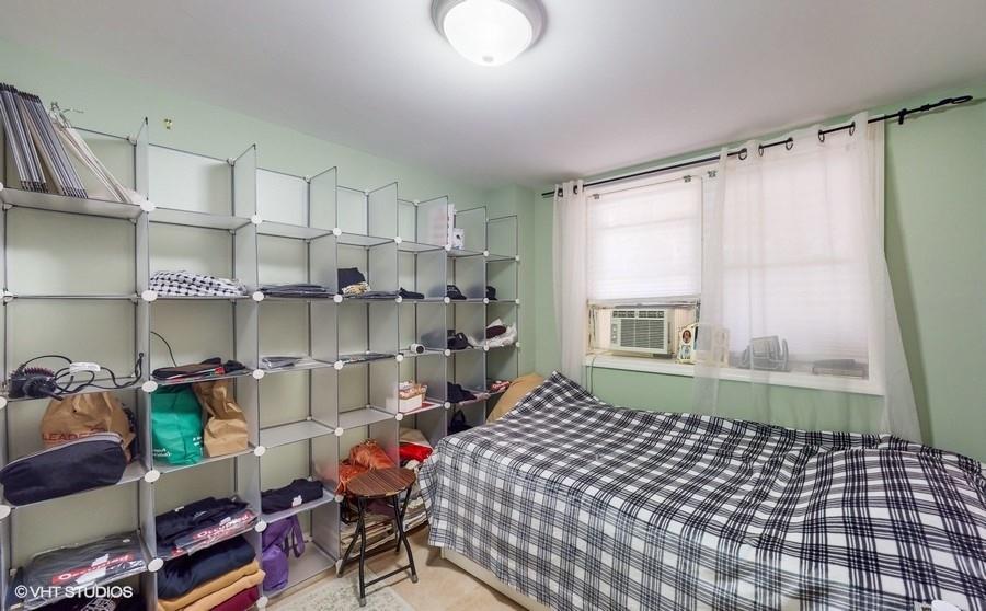 340 86th Street Brooklyn, NY 11209 - Photo 16 of 20 a bedroom with a bed and a window