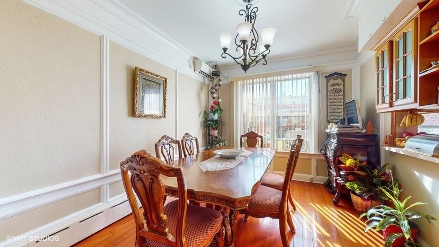 340 86th Street Brooklyn, NY 11209 - Photo 6 of 20 a view of a dining room with furniture a chandelier and wooden floor