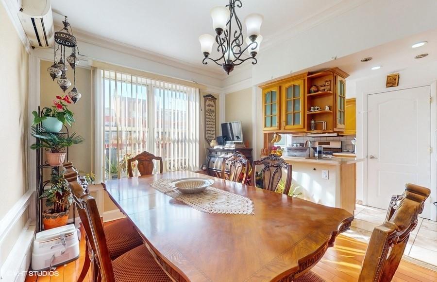340 86th Street Brooklyn, NY 11209 - Photo 7 of 20 a view of a dining room with furniture a chandelier and wooden floor