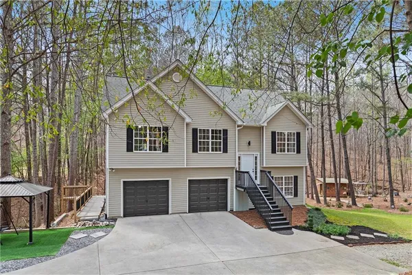 a view of house with outdoor space and parking