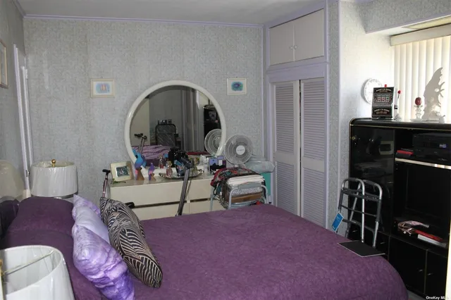 a living room with furniture a flat screen tv and a mirror