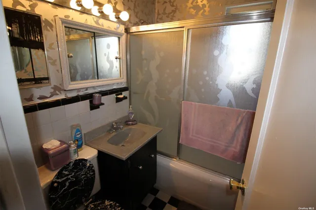 a bathroom with a sink vanity and a mirror