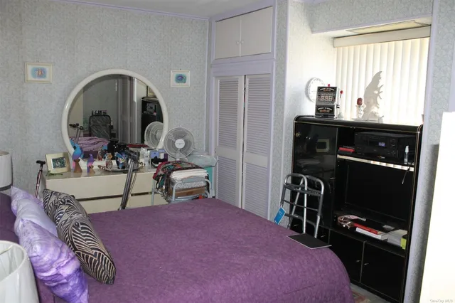 a living room with furniture a flat tv screen and a dresser
