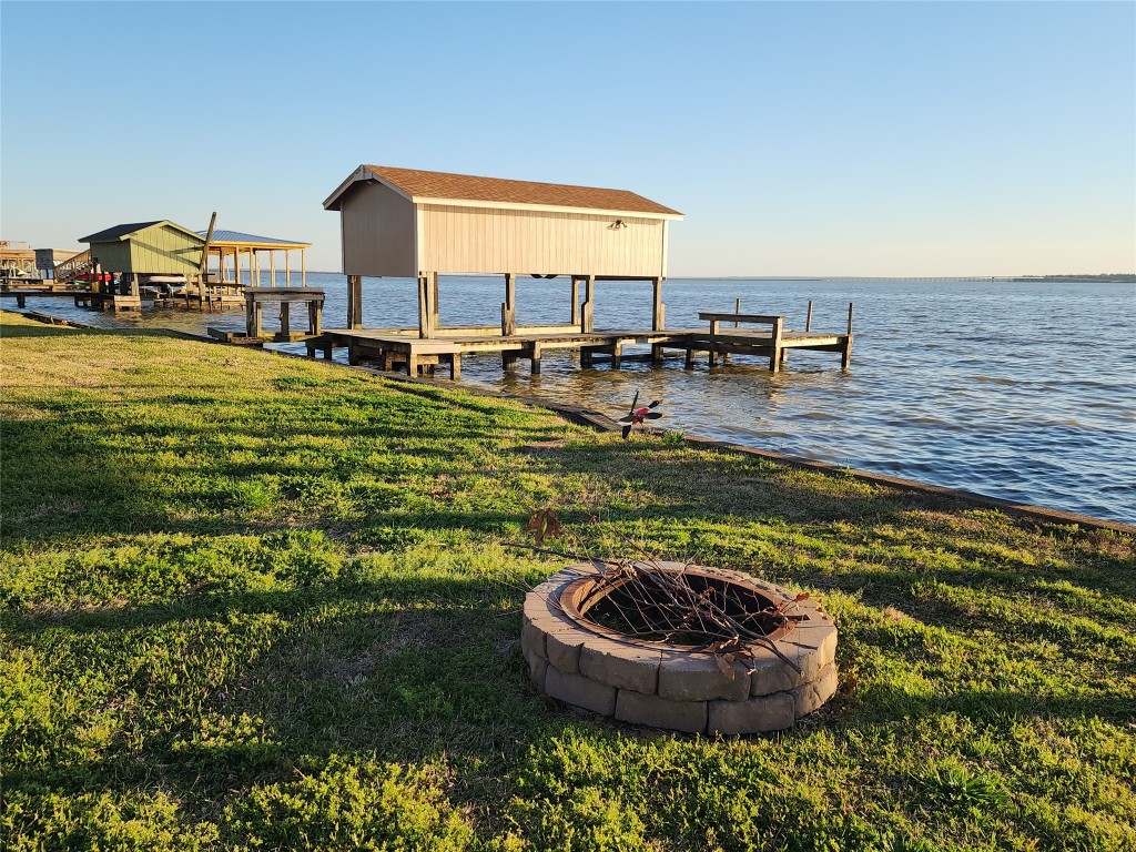 482 West Cattle Drive Onalaska, TX 77360 - Photo 6 of 34 a swimming pool with outdoor seating and yard