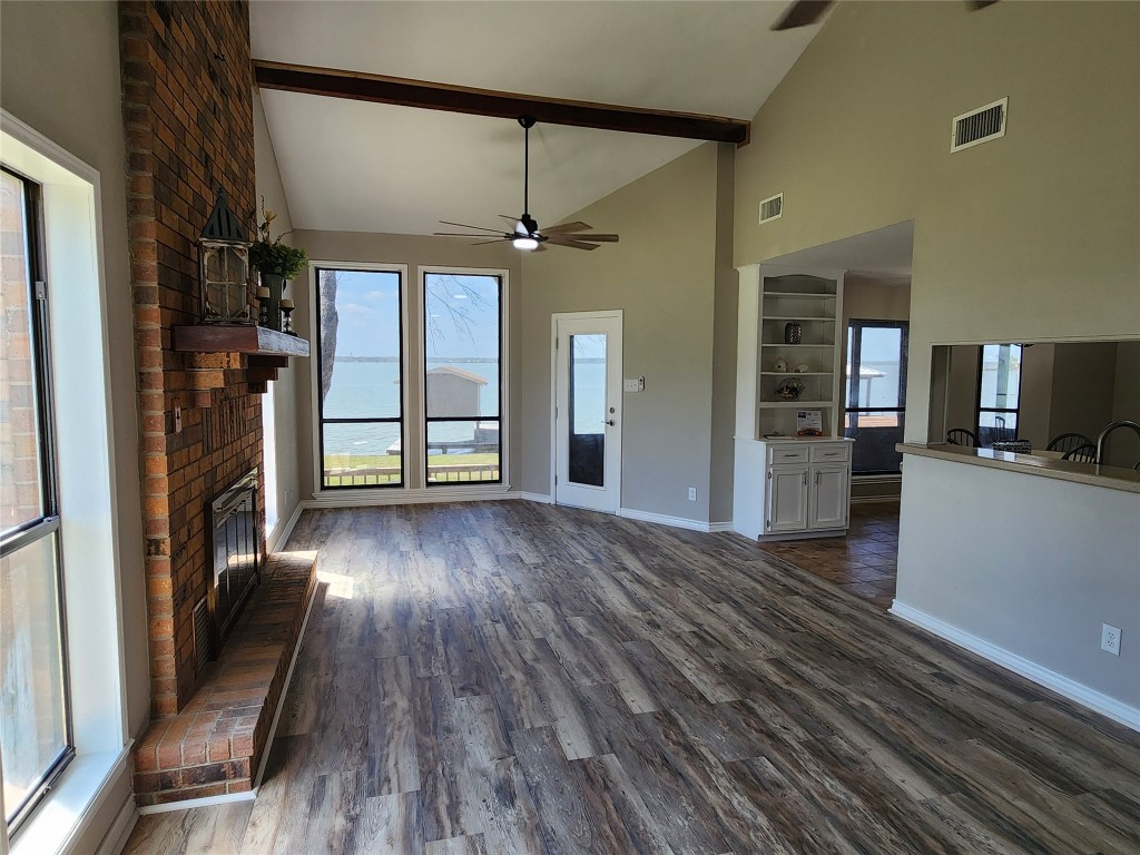 482 West Cattle Drive Onalaska, TX 77360 - Photo 10 of 34 wooden floor in an empty room with a fireplace