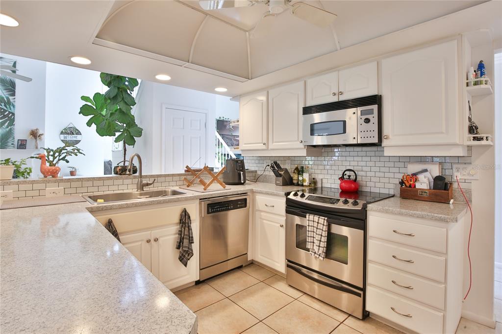 7303 Manatee Street Sarasota, FL 34243 - Photo 15 of 39 a kitchen with stainless steel appliances granite countertop a sink and cabinets