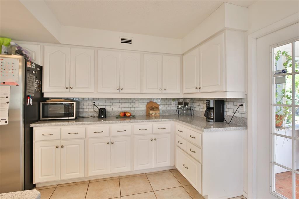 7303 Manatee Street Sarasota, FL 34243 - Photo 16 of 39 a kitchen with white cabinets and white appliances