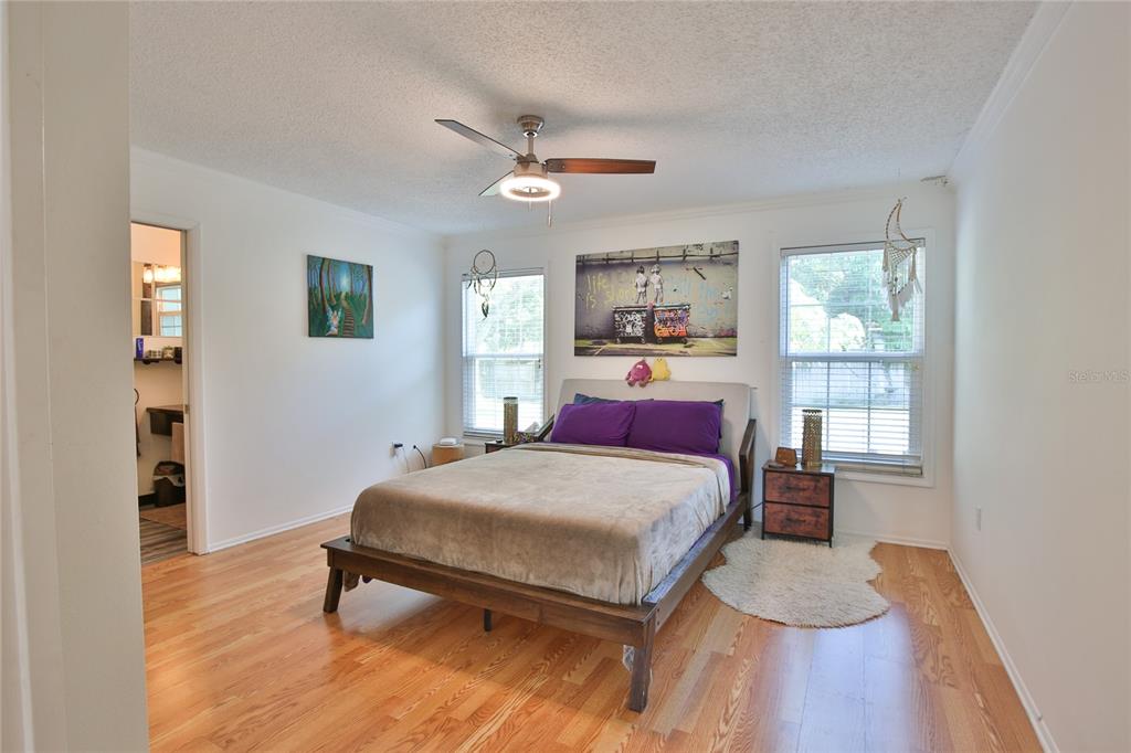 7303 Manatee Street Sarasota, FL 34243 - Photo 18 of 39 a bedroom with a bed and wooden floor