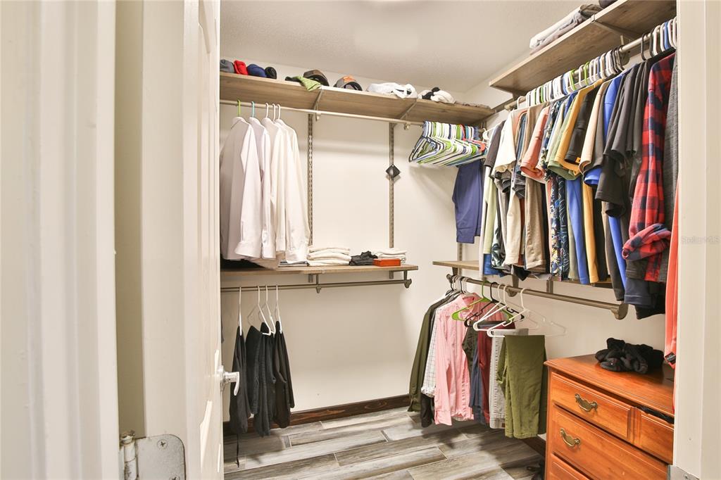 7303 Manatee Street Sarasota, FL 34243 - Photo 22 of 39 a view of walk in closet with clothes and shoes