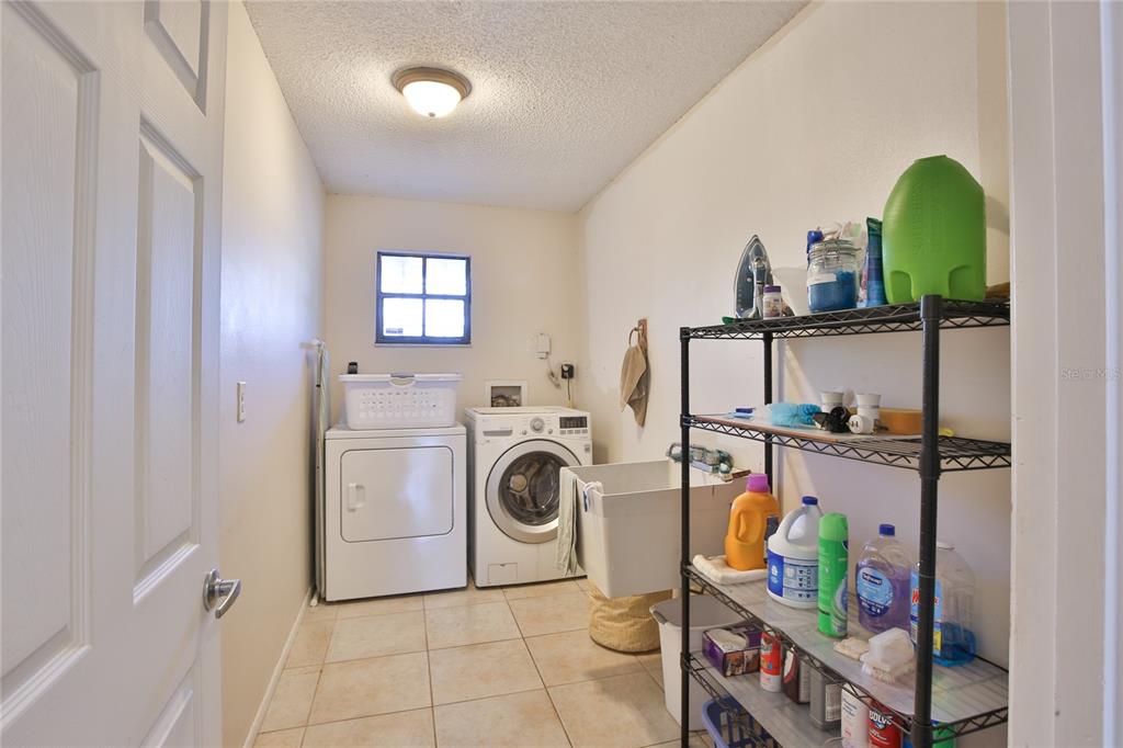 7303 Manatee Street Sarasota, FL 34243 - Photo 25 of 39 a utility room with dryer and washer