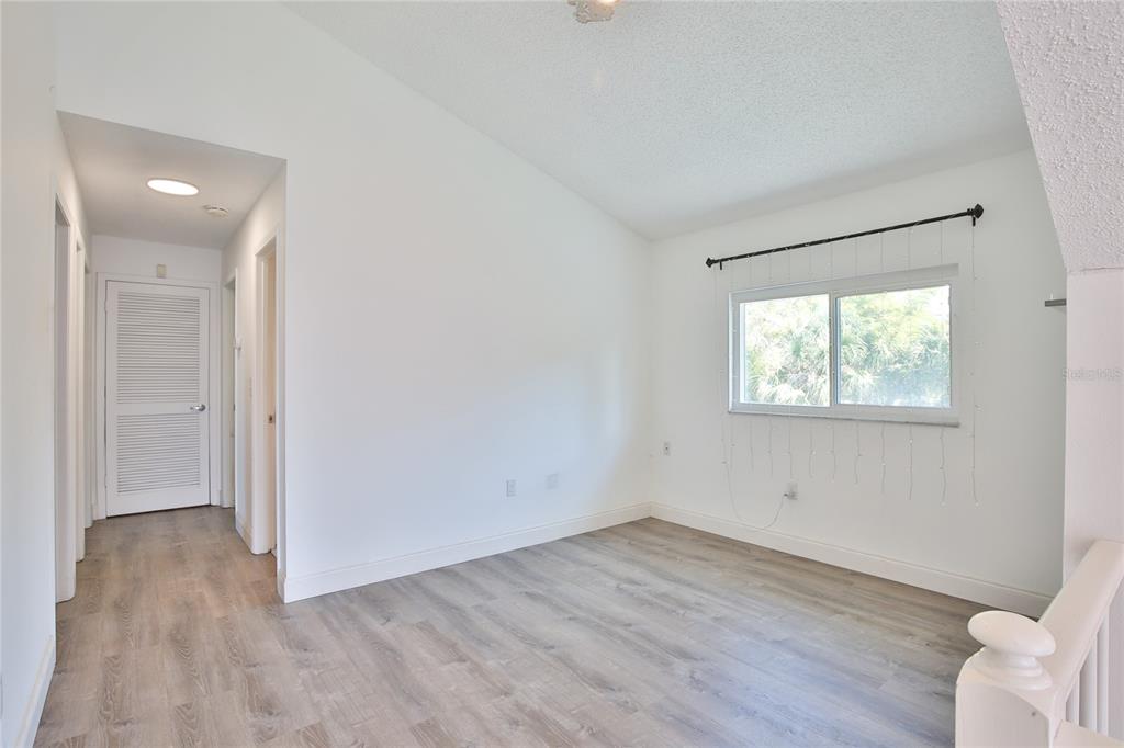 7303 Manatee Street Sarasota, FL 34243 - Photo 26 of 39 an empty room with wooden floor and windows