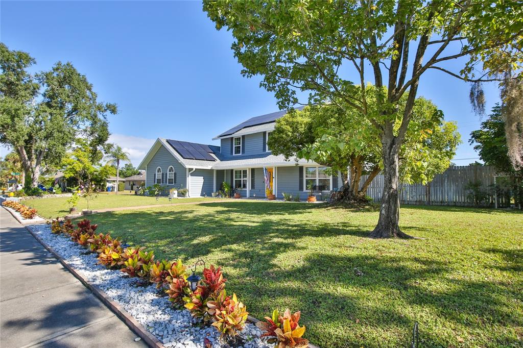 7303 Manatee Street Sarasota, FL 34243 - Photo 3 of 39 a front view of a house with garden