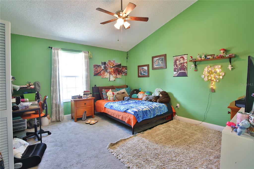 7303 Manatee Street Sarasota, FL 34243 - Photo 31 of 39 a bedroom with two beds and a window