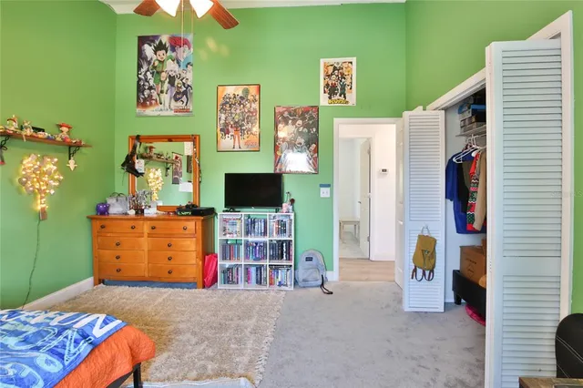 a bedroom with a bed and a television