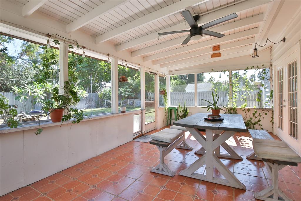 7303 Manatee Street Sarasota, FL 34243 - Photo 34 of 39 a living room with furniture and a floor to ceiling window