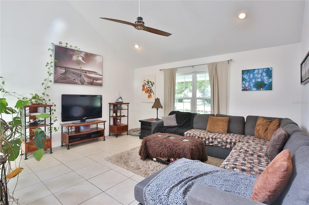 7303 Manatee Street Sarasota, FL 34243 - Photo 8 of 39 a living room with furniture and a flat screen tv