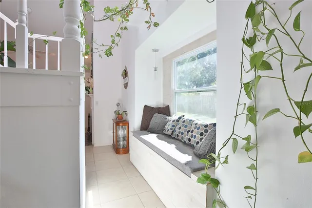 a living room with furniture and a floor to ceiling window