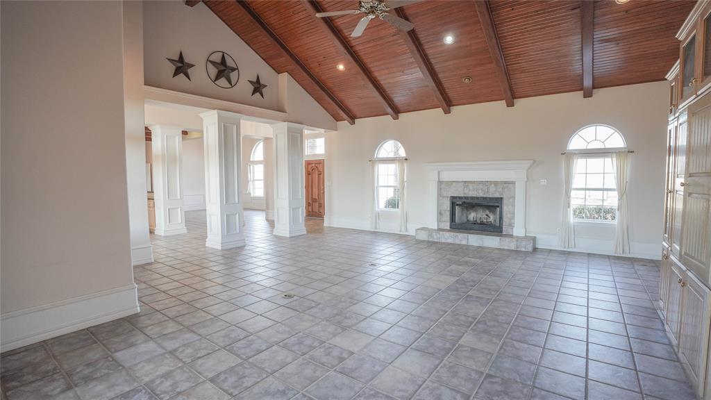 1041 Clarence Road Temple, TX 76501 - Photo 12 of 36 a view of an empty room with a fireplace and a window