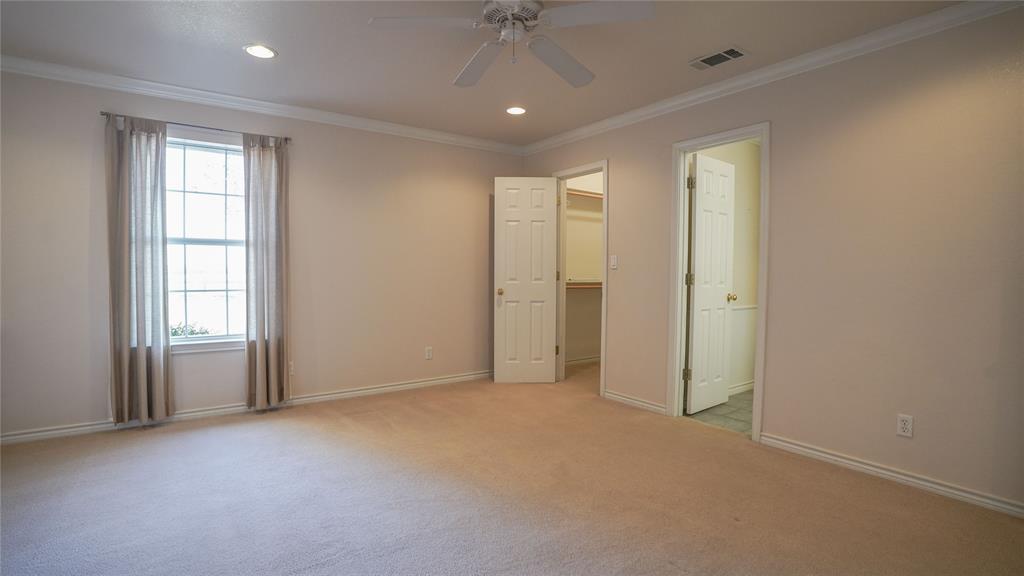 1041 Clarence Road Temple, TX 76501 - Photo 16 of 36 an empty room with windows and chandelier fan