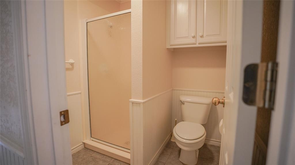 1041 Clarence Road Temple, TX 76501 - Photo 17 of 36 a white toilet sitting next to a shower