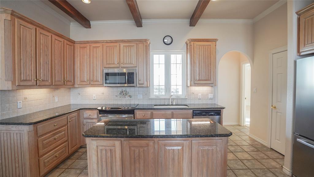 1041 Clarence Road Temple, TX 76501 - Photo 20 of 36 a kitchen with granite countertop a sink and a white cabinets