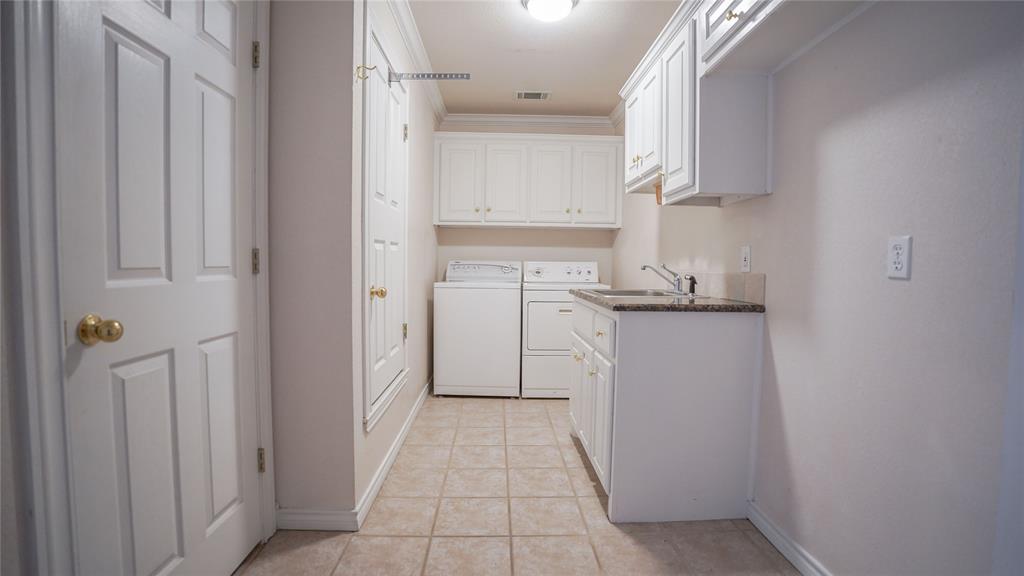 1041 Clarence Road Temple, TX 76501 - Photo 26 of 36 a kitchen with white cabinets and refrigerator