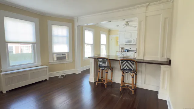 a dining room with furniture and wooden floor