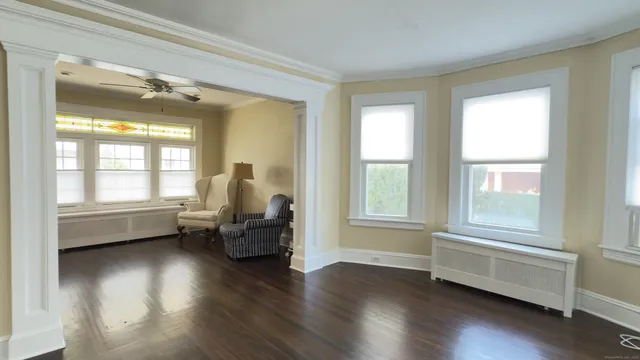 a living room with furniture wooden floor and a window