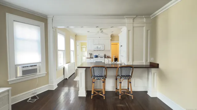 a view of a kitchen with a table and chairs