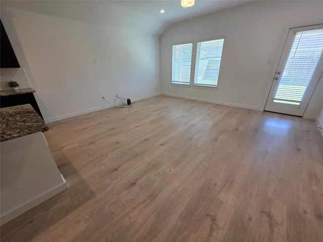 a view of a kitchen with a sink and a refrigerator