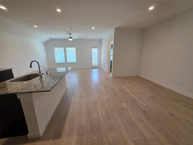 a kitchen with stainless steel appliances granite countertop a refrigerator stove and microwave