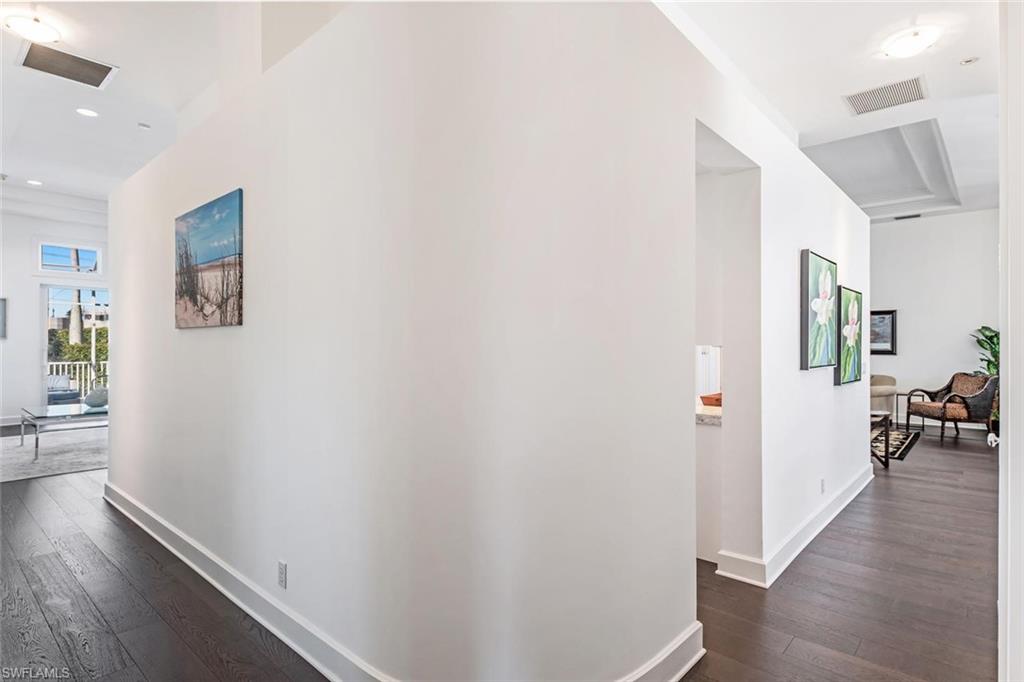 2540 Half Moon Walk Naples, FL 34102 - Photo 22 of 44 a view of a hallway with wooden floor and a living room