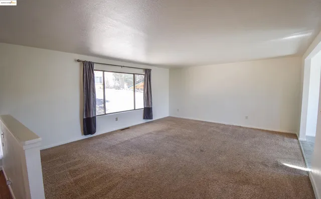 an empty room with a empty space and windows