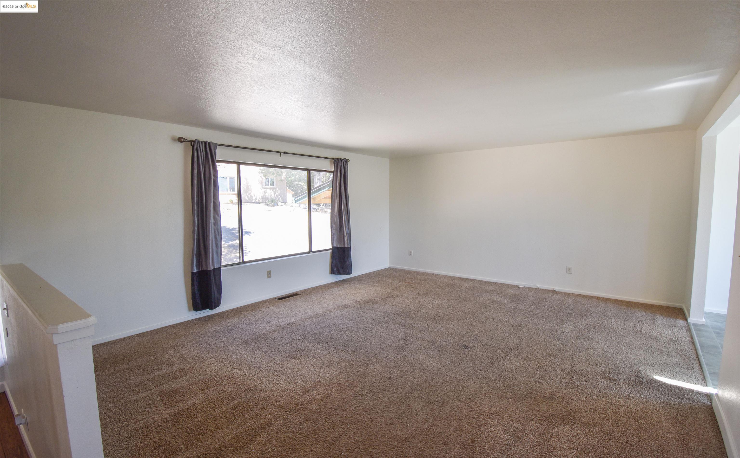 21850 Phoenix Lake Road Sonora, CA 95370 - Photo 11 of 39 an empty room with windows