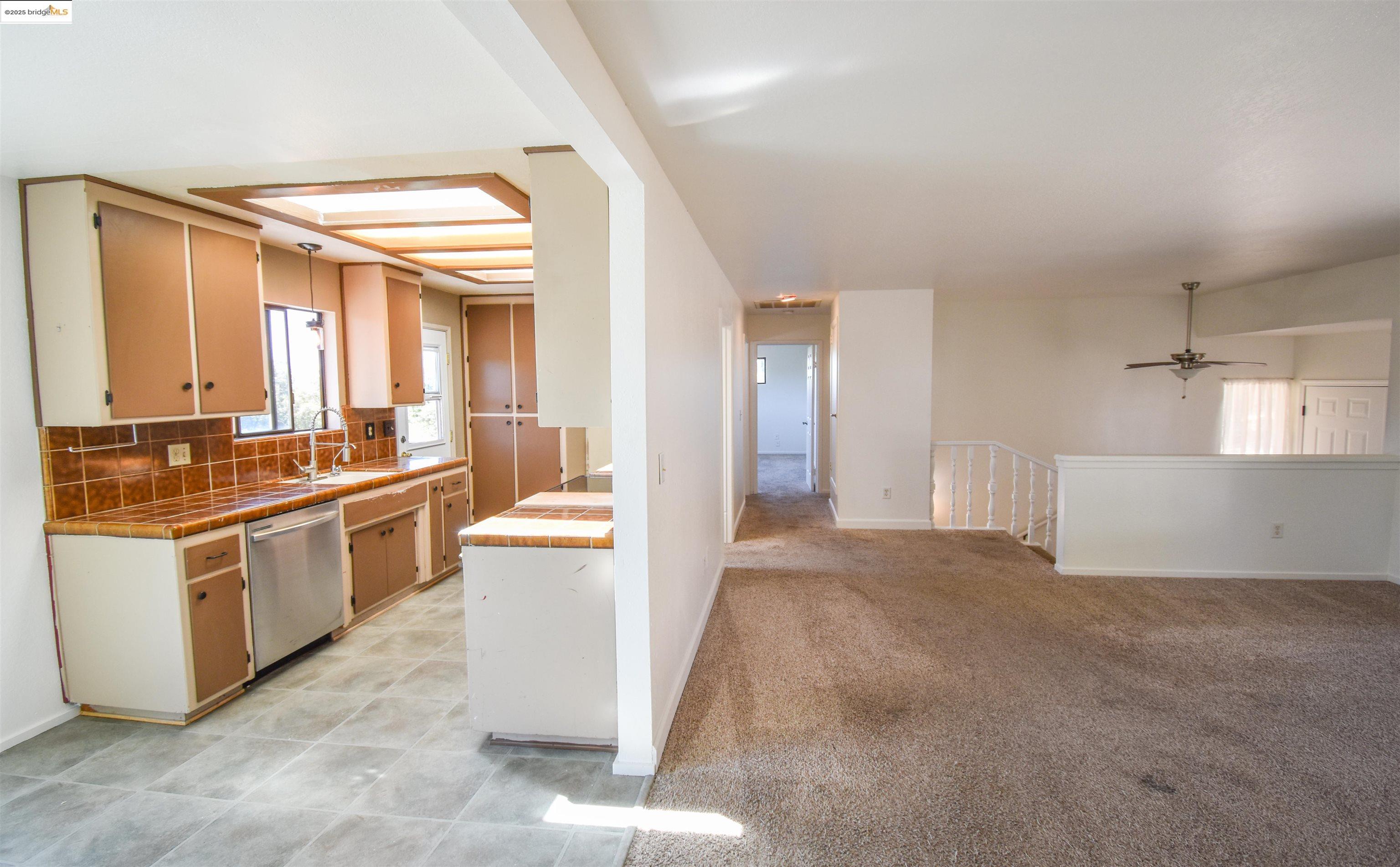 21850 Phoenix Lake Road Sonora, CA 95370 - Photo 14 of 39 a large white kitchen with stainless steel appliances granite countertop a stove and a sink