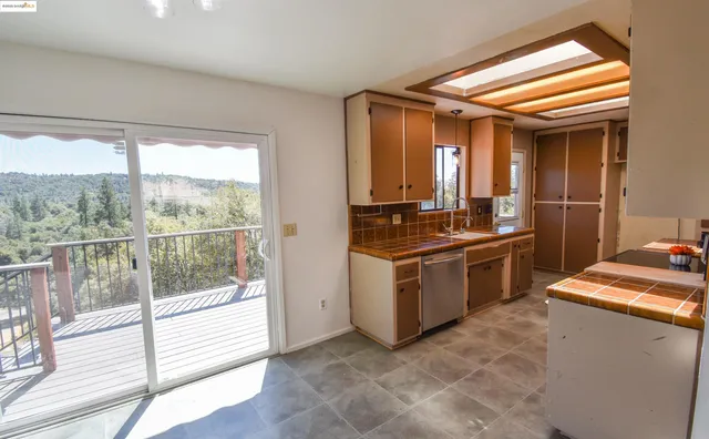 a large kitchen with kitchen island a stove a sink and a refrigerator